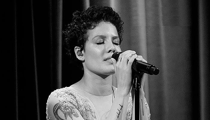 Halsey singing at the mic